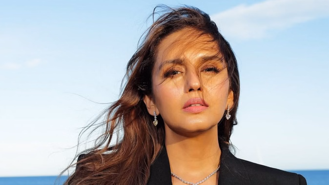 हुमा कुरैशी कान्स फिल्म फेस्टिवल में फ्रेंच रिवेरा की पृष्ठभूमि के साथ एक काले रंग की बॉस लेडी पोशाक में पोज देती नजर आईं।